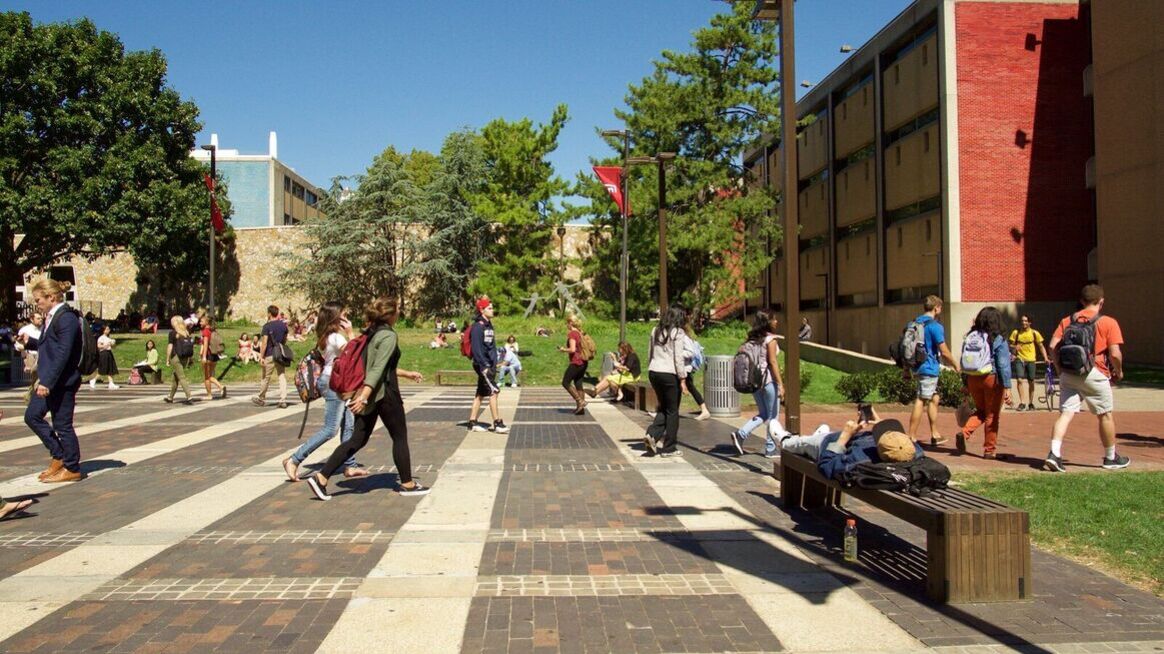 Students walking across a university campus