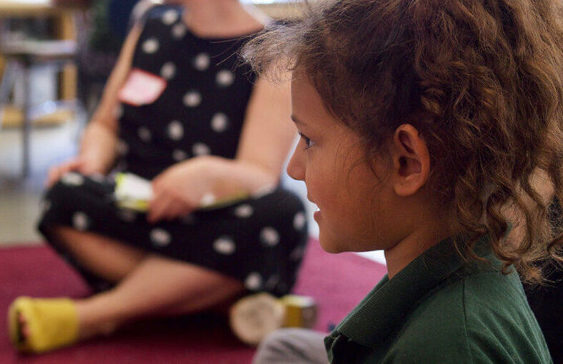 A student looking across the room at their teacher