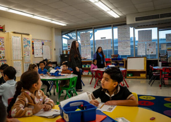 A teacher-candidate works in her mentor teacher's classroom